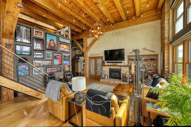 1545 Arboretum Dr Unit 315, Oshkosh, WI 54901 - living area featuring wooden ceiling with exposed beams, healthy amount of natural light, wood finished floors, a high ceiling, and a chandelier