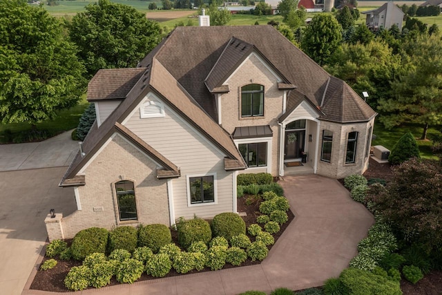5015 Joshua Dr, West Bend, WI 53090 - french country style house with brick siding and a shingled roof