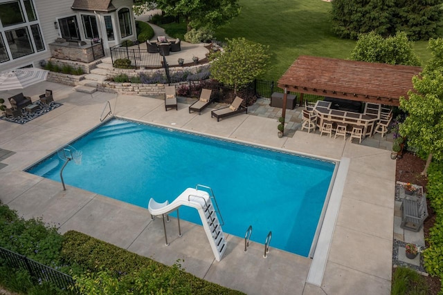 5015 Joshua Dr, West Bend, WI 53090 - view of swimming pool featuring a water slide and a patio