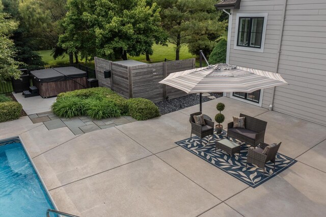 5015 Joshua Dr, West Bend, WI 53090 - view of patio / terrace with a hot tub, an outdoor pool, and outdoor lounge area