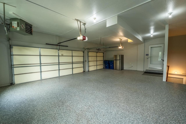 5015 Joshua Dr, West Bend, WI 53090 - garage with a garage door opener, freestanding refrigerator, and a heating unit