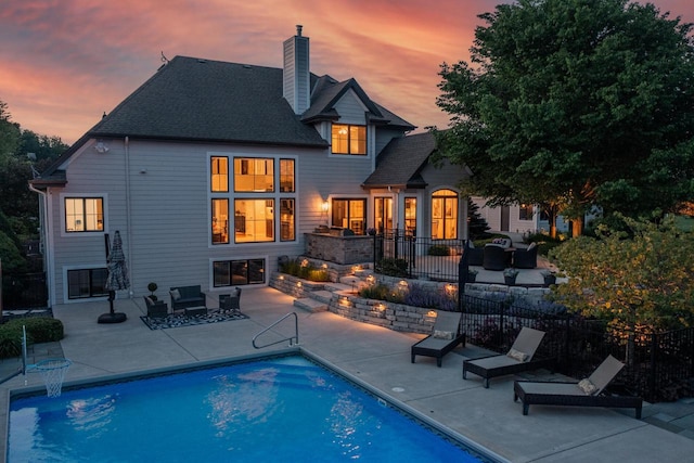 5015 Joshua Dr, West Bend, WI 53090 - rear view of property with a patio, outdoor lounge area, a chimney, and a shingled roof