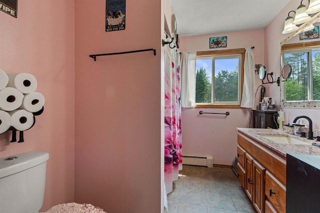 7320 Deer Rd, Wisconsin Rapids, WI 54494 - bathroom featuring a baseboard radiator, toilet, vanity, and baseboards