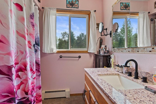 7320 Deer Rd, Wisconsin Rapids, WI 54494 - full bath featuring a baseboard radiator, healthy amount of natural light, vanity, and baseboards