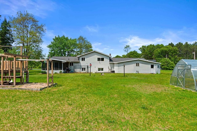7320 Deer Rd, Wisconsin Rapids, WI 54494 - rear view of property featuring a greenhouse, an outbuilding, a lawn, and a playground