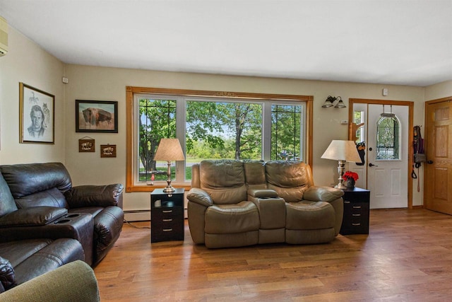 7320 Deer Rd, Wisconsin Rapids, WI 54494 - living area featuring plenty of natural light, wood finished floors, and a baseboard heating unit