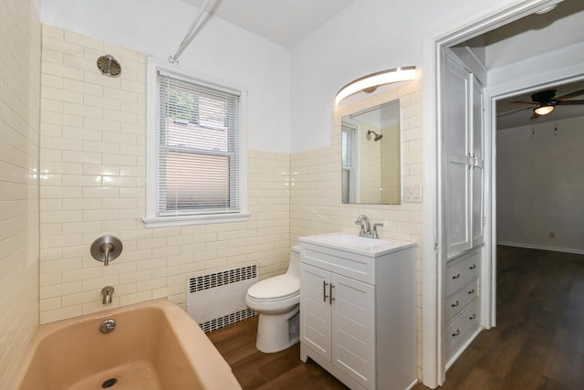 3380 N 39th St, Milwaukee, WI 53216 - full bath featuring radiator heating unit, tile walls, wood finished floors, vanity, and toilet