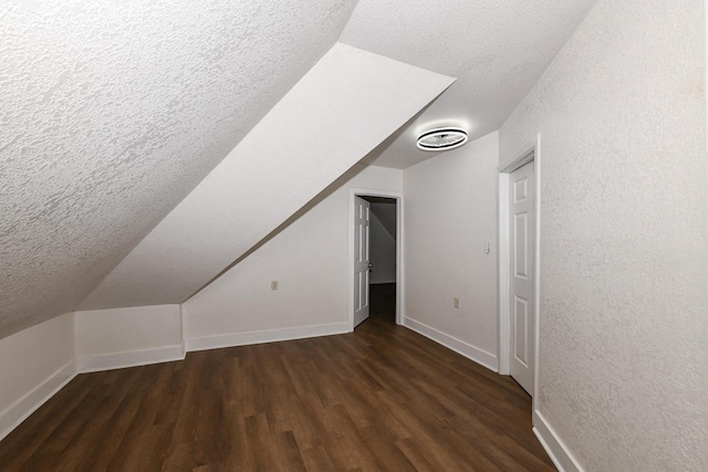 3380 N 39th St, Milwaukee, WI 53216 - additional living space with a textured ceiling, wood finished floors, baseboards, and lofted ceiling