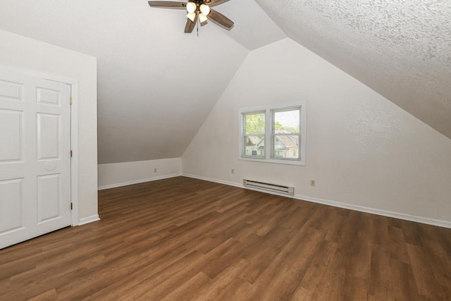 3380 N 39th St, Milwaukee, WI 53216 - additional living space with baseboard heating, a ceiling fan, wood finished floors, baseboards, and lofted ceiling