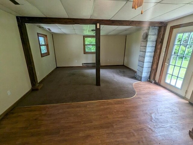 501 S Main St, Loyal, WI 54446 - empty room featuring a baseboard radiator, baseboards, a drop ceiling, and wood finished floors