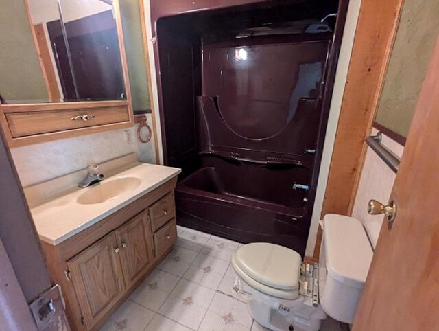 501 S Main St, Loyal, WI 54446 - bathroom with toilet, vanity, tile patterned floors, and shower / bath combination
