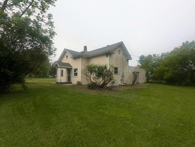 501 S Main St, Loyal, WI 54446 - view of property exterior with a yard and a chimney