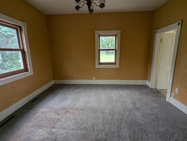 501 S Main St, Loyal, WI 54446 - spare room featuring a chandelier, carpet flooring, and baseboards