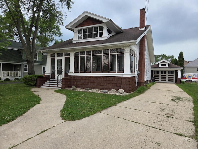 2073 Beulah Ave, East Troy, WI 53120 - view of front facade featuring a chimney, a front lawn, an outdoor structure, and driveway