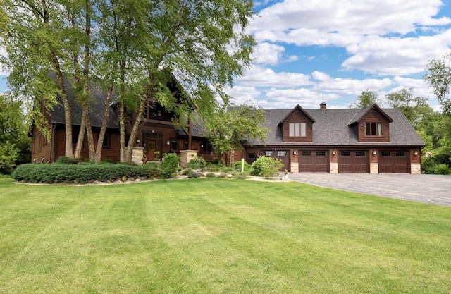W395S3611 Hardscrabble Rd, Dousman, WI 53118 - view of front of property featuring a front lawn, stone siding, a chimney, a shingled roof, and a detached garage