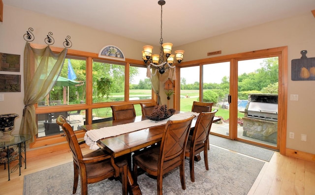 W395S3611 Hardscrabble Rd, Dousman, WI 53118 - dining area featuring a chandelier, healthy amount of natural light, and light wood-style flooring