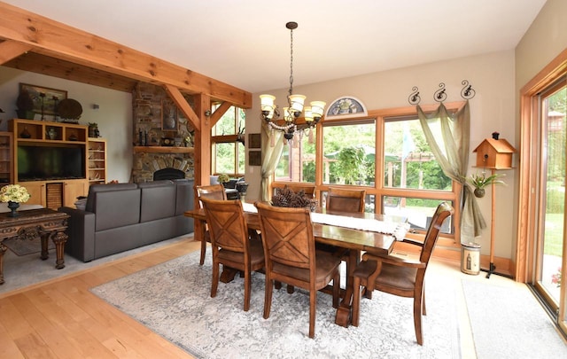 W395S3611 Hardscrabble Rd, Dousman, WI 53118 - dining space featuring hardwood / wood-style flooring, a chandelier, a stone fireplace, and beam ceiling