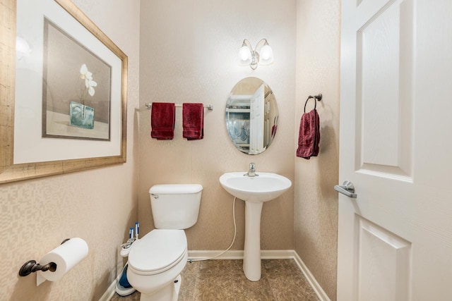 N17W26535 Meadowgrass Cir Unit G, Pewaukee, WI 53072 - half bathroom featuring toilet, baseboards, and a sink