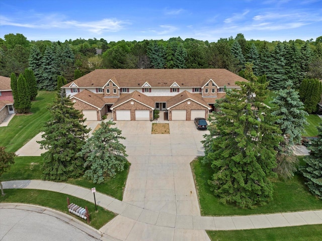 1507 Clarence Ct Unit 5, West Bend, WI 53095 - view of front of property with concrete driveway, a garage, and a view of trees