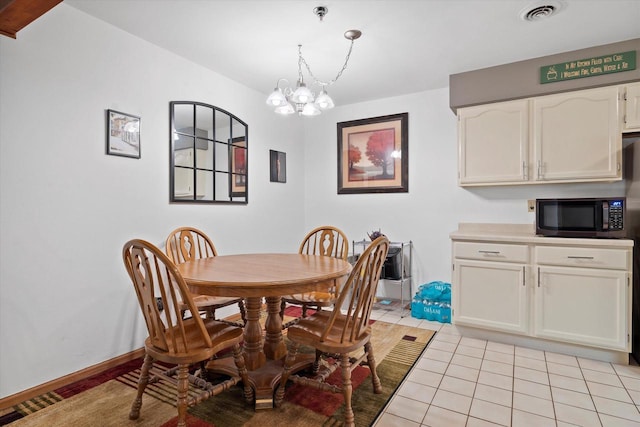 1507 Clarence Ct Unit 5, West Bend, WI 53095 - dining area featuring a chandelier and light tile patterned floors