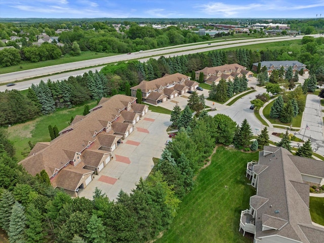 1507 Clarence Ct Unit 5, West Bend, WI 53095 - aerial view of property and surrounding area with nearby suburban area and a tree filled landscape