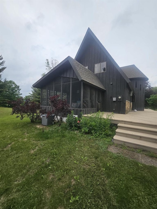 5317 Old C Rd, Boscobel, WI 53805 - back of property with a sunroom, board and batten siding, a deck, a lawn, and cooling unit