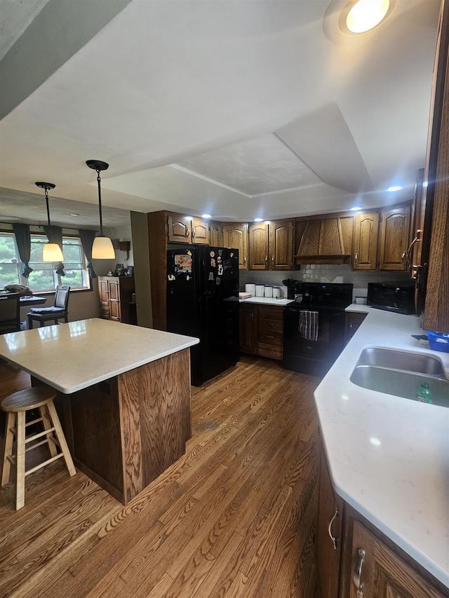 5317 Old C Rd, Boscobel, WI 53805 - kitchen with freestanding refrigerator, a sink, dark wood-style floors, light countertops, and a center island