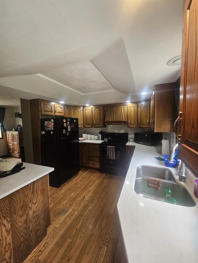 5317 Old C Rd, Boscobel, WI 53805 - kitchen with black appliances, a sink, dark wood-style flooring, custom range hood, and light countertops