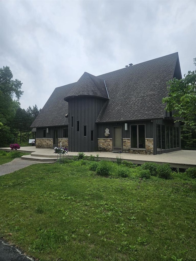 5317 Old C Rd, Boscobel, WI 53805 - view of property exterior featuring board and batten siding, roof with shingles, a yard, and stone siding
