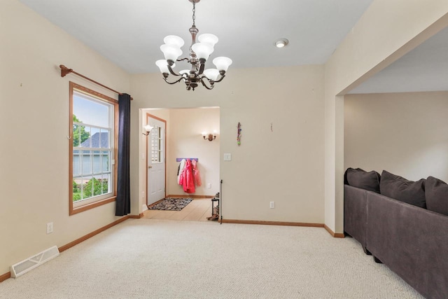 2432 Forest Hill Ct, Waukesha, WI 53188 - foyer featuring a chandelier, light carpet, and baseboards
