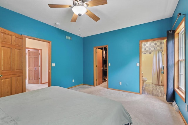 2432 Forest Hill Ct, Waukesha, WI 53188 - carpeted bedroom with ensuite bath, baseboards, a walk in closet, and ceiling fan