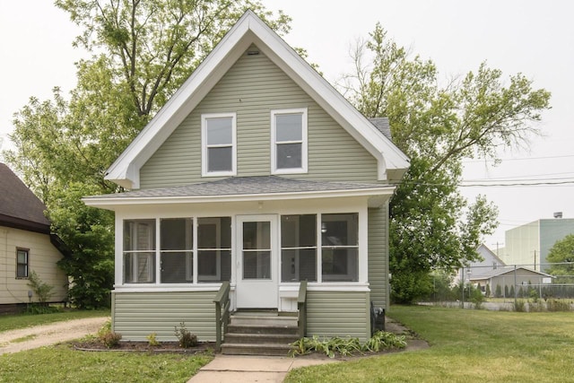912 Harvey St, Beloit, WI 53511 - view of front facade with roof with shingles, a sunroom, and entry steps