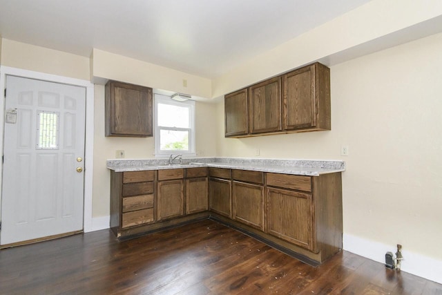 912 Harvey St, Beloit, WI 53511 - kitchen featuring dark wood finished floors, light countertops, and a sink