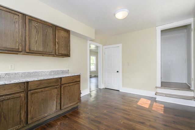 912 Harvey St, Beloit, WI 53511 - kitchen featuring dark wood-style floors, light countertops, and baseboards