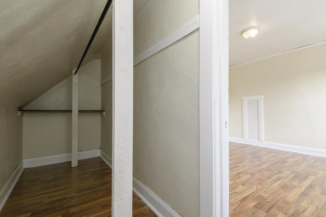 912 Harvey St, Beloit, WI 53511 - additional living space with wood finished floors, vaulted ceiling, and baseboards