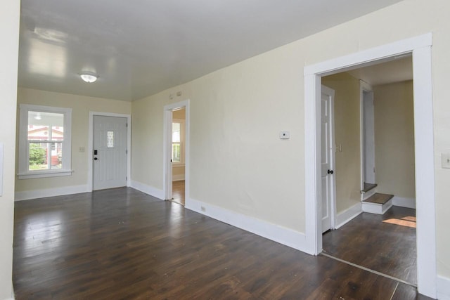 912 Harvey St, Beloit, WI 53511 - unfurnished room with dark wood-style flooring, plenty of natural light, and baseboards