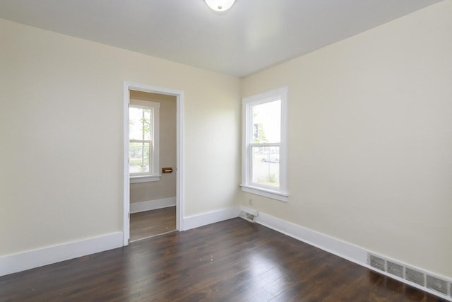 912 Harvey St, Beloit, WI 53511 - unfurnished room with baseboards and dark wood-style flooring