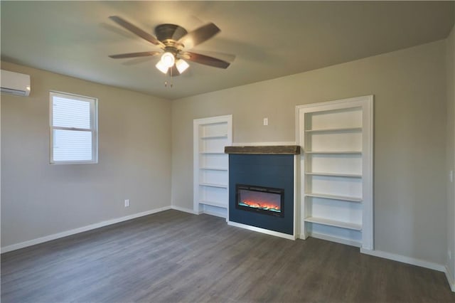 1226 Bellevue Ave, Eau Claire, WI 54703 - unfurnished living room with a wall mounted AC, baseboards, dark wood-type flooring, ceiling fan, and a glass covered fireplace