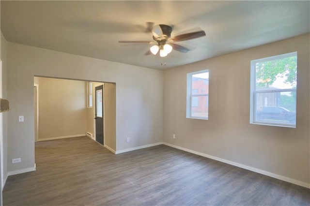 1226 Bellevue Ave, Eau Claire, WI 54703 - spare room with a ceiling fan, dark wood-style floors, and baseboards