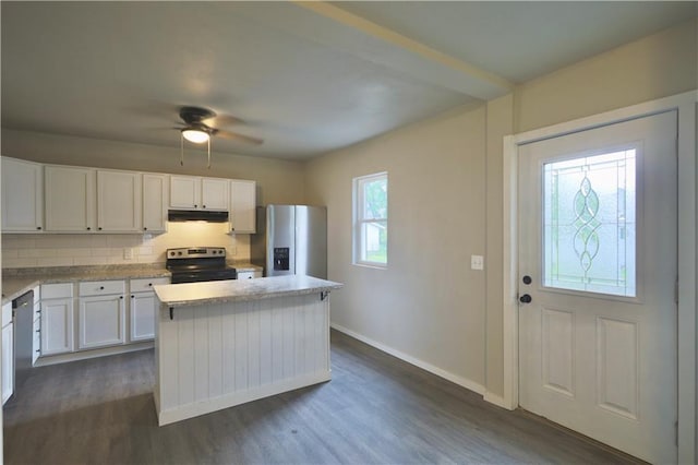 1226 Bellevue Ave, Eau Claire, WI 54703 - kitchen featuring stainless steel appliances, under cabinet range hood, a kitchen island, white cabinetry, and dark wood-style flooring