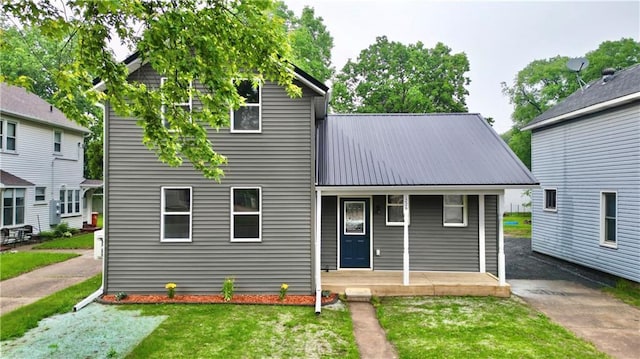 1226 Bellevue Ave, Eau Claire, WI 54703 - view of front of home featuring a porch, metal roof, and a front lawn
