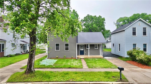 1226 Bellevue Ave, Eau Claire, WI 54703 - traditional home featuring a front yard, metal roof, and covered porch