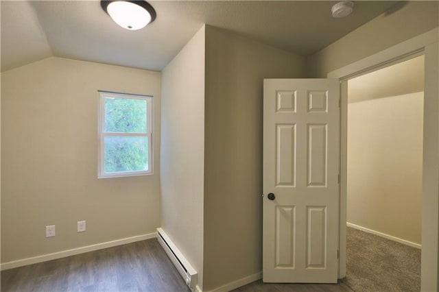 1226 Bellevue Ave, Eau Claire, WI 54703 - unfurnished bedroom featuring a baseboard heating unit, lofted ceiling, baseboards, and dark wood-style flooring
