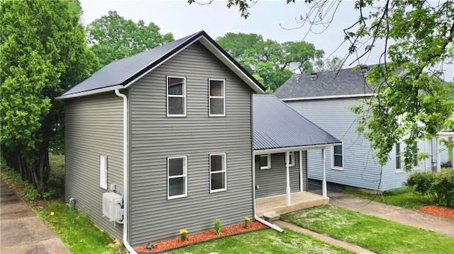 1226 Bellevue Ave, Eau Claire, WI 54703 - back of property featuring ac unit, a lawn, and a porch