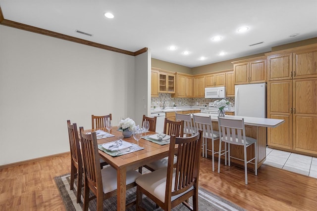 6758 Raymond Rd Unit 109, Madison, WI 53719 - dining space featuring ornamental molding, light wood-style flooring, and recessed lighting