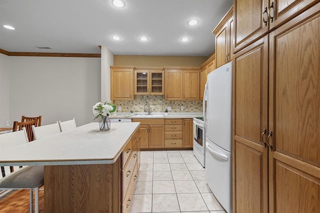 6758 Raymond Rd Unit 109, Madison, WI 53719 - kitchen featuring white appliances, a kitchen bar, decorative backsplash, light countertops, and ornamental molding