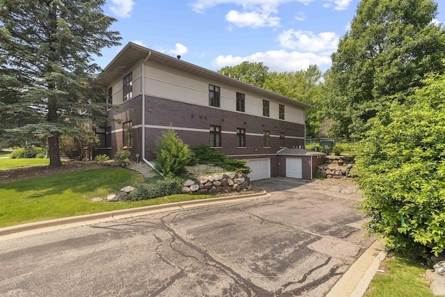 6758 Raymond Rd Unit 109, Madison, WI 53719 - view of property with an attached garage and asphalt driveway