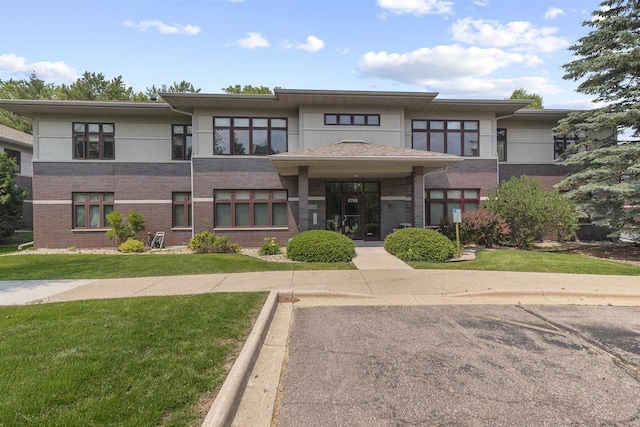 6758 Raymond Rd Unit 109, Madison, WI 53719 - view of front of property with brick siding, a front lawn, and stucco siding