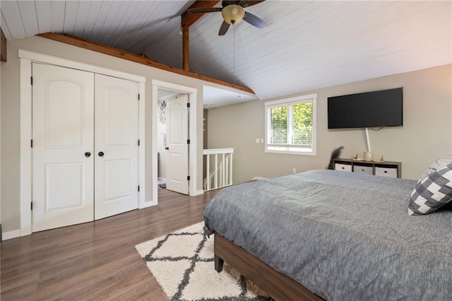 bedroom featuring vaulted ceiling, wood ceiling, wood finished floors, ceiling fan, and a closet