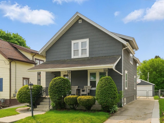 409 Huron St, Manitowoc, WI 54220 - view of front facade with a porch, an outdoor structure, a garage, and a front yard